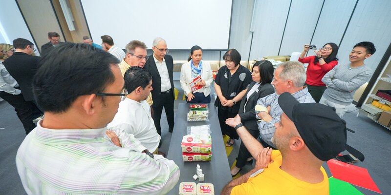 art students look at paint samples at the Dow Exposure station