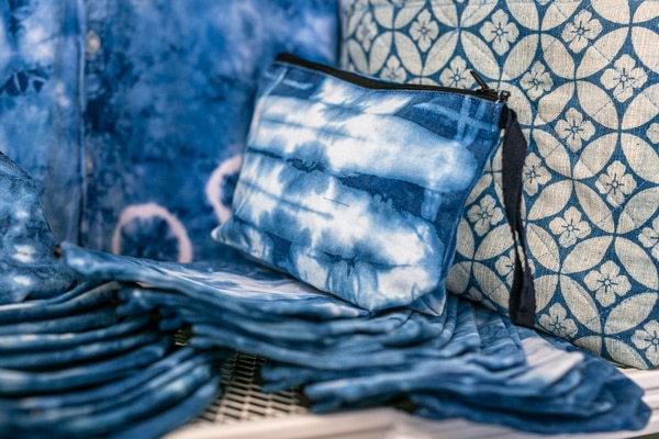 A blue and white fabric with a bag and a pillow